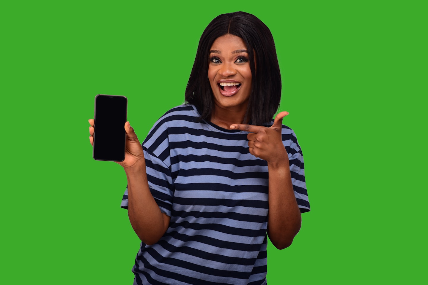 Creator in a studio checking a phone, showing the reality of fan demand, churn, and subscription pricing
