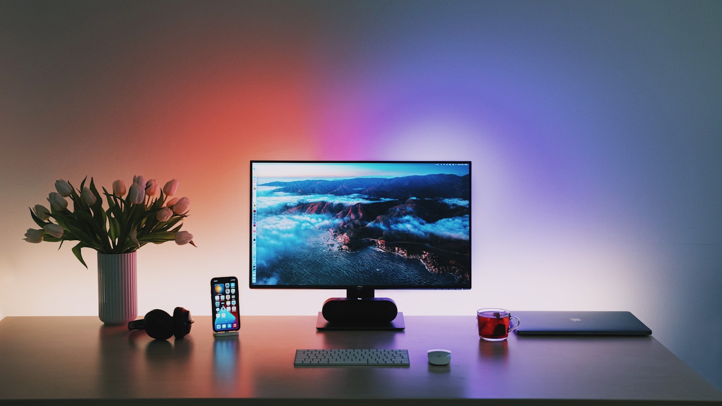 Clean desk setup with laptop and planning materials for launching an OnlyFans business