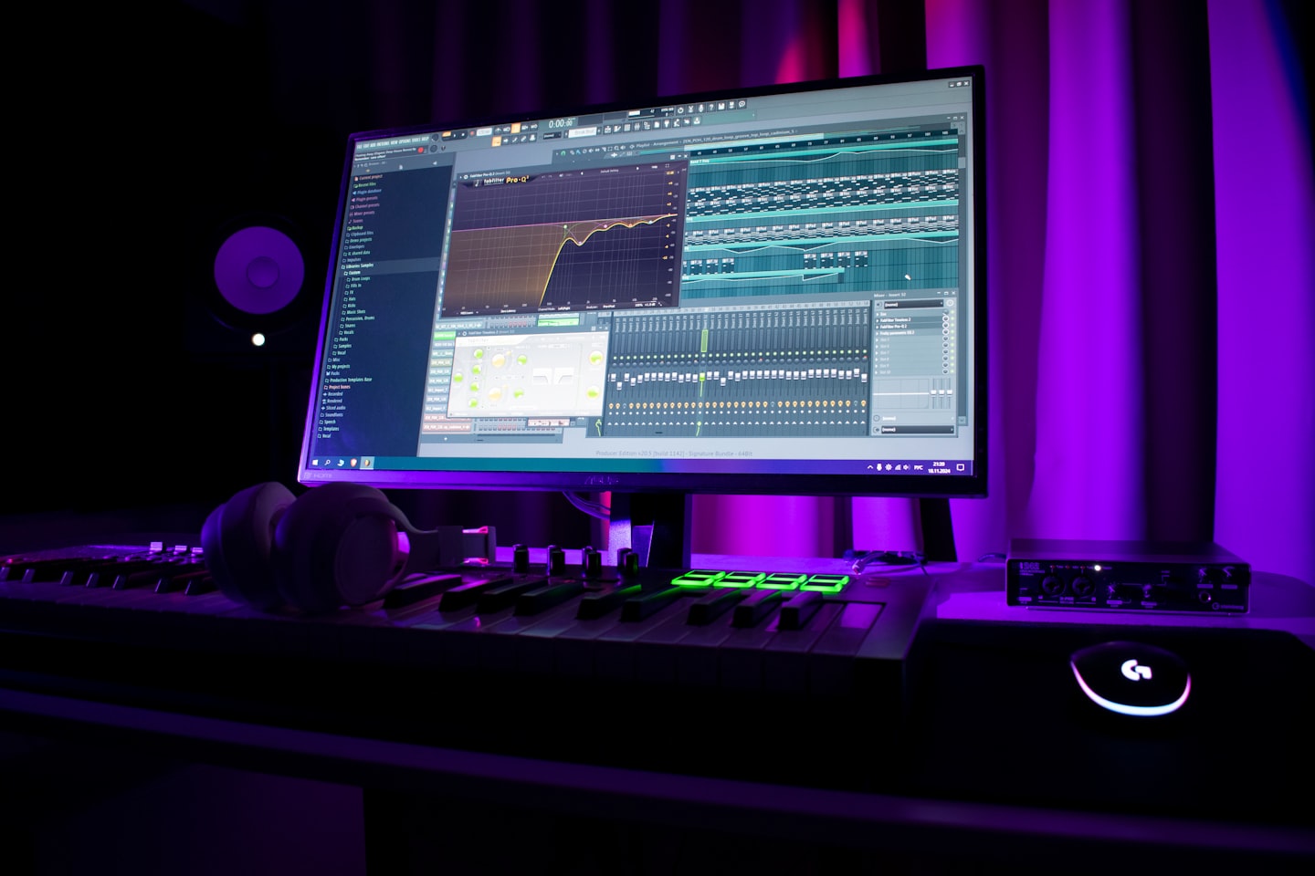 A studio monitor displays a digital portfolio and income-style dashboard in a creator workspace.