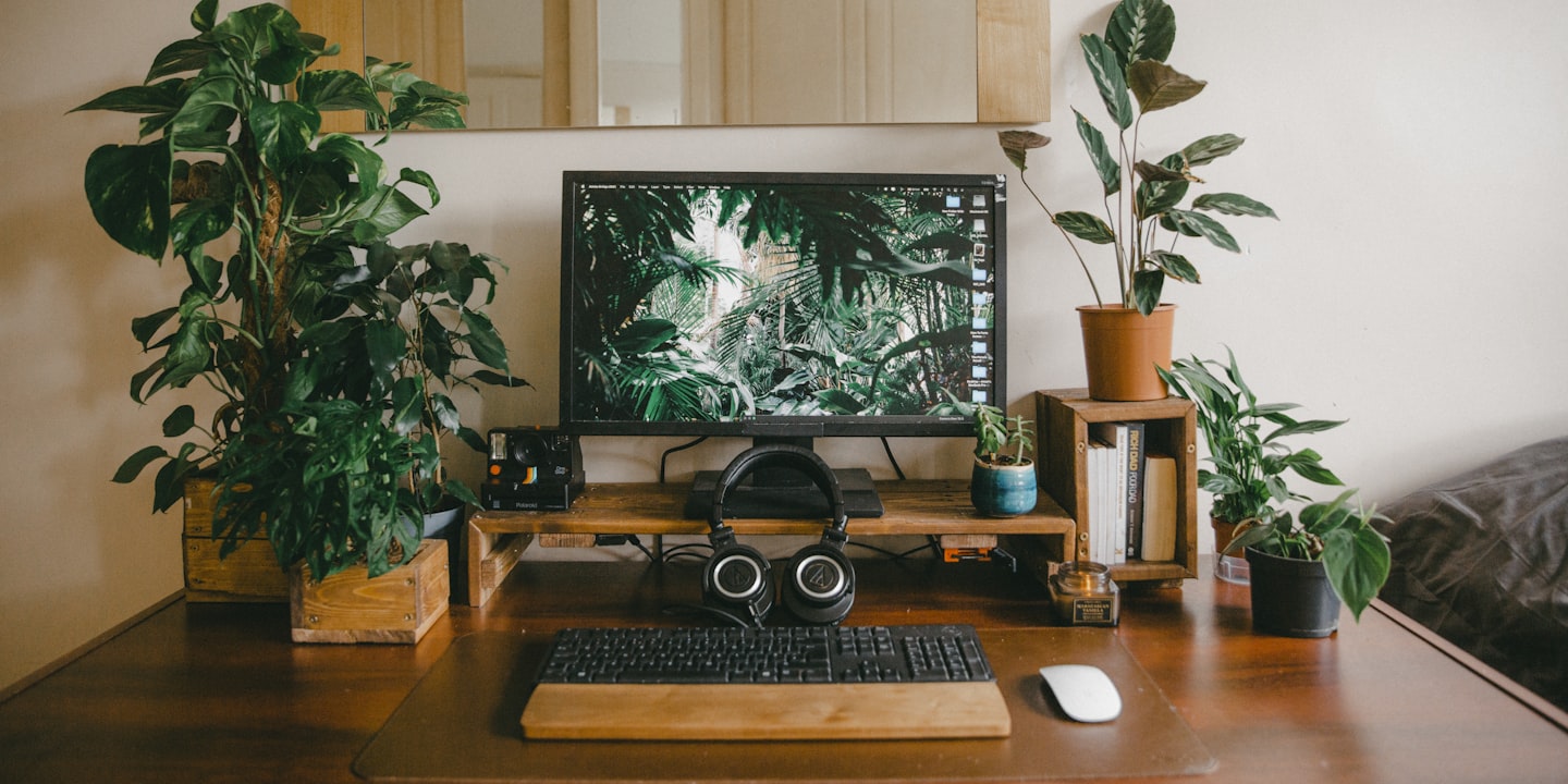 Modern desk setup with a laptop and monitor in a clean creator workspace