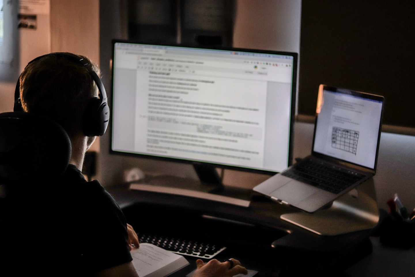 Workspace with a monitor showing analytics and subscription planning for a creator business