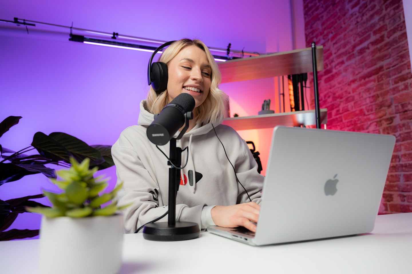 A content creator in a modern studio using social media posts and replies to build trust and drive traffic.