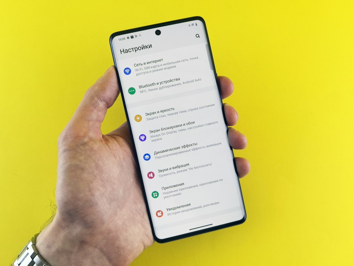 Person checking subscription settings on a phone in a bright modern setting