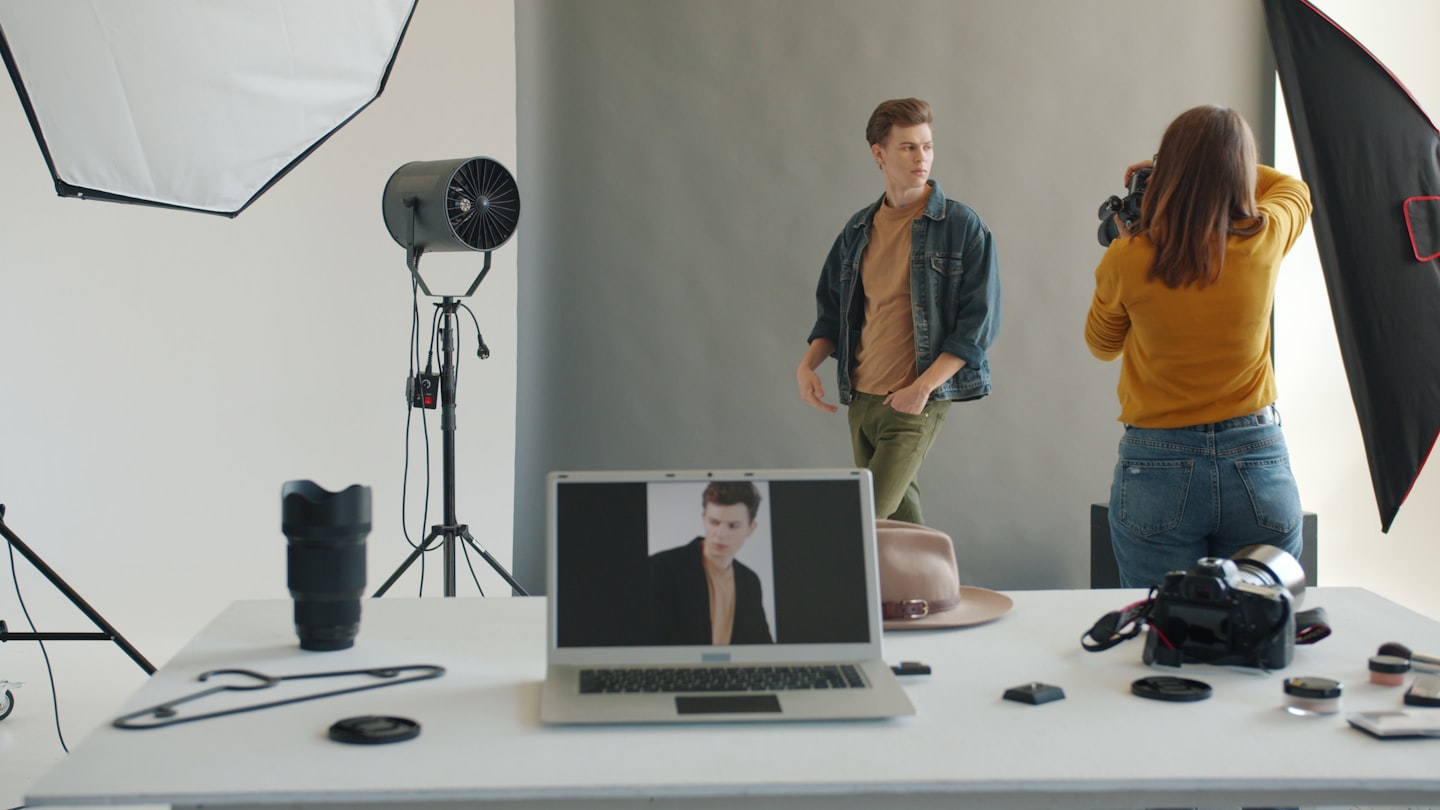 Photographer taking picture of male mannequin in studio